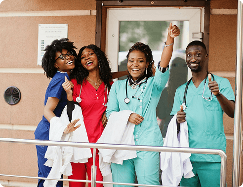 Group of medical professionals in scrubs celebrating together