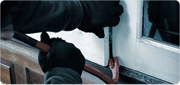Gloved hand breaking a window