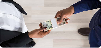 Cash being handed over between two people