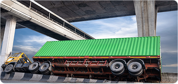 Flatbed truck carrying cargo under a bridge