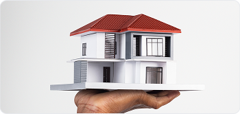 Model house held in hand, representing home insurance